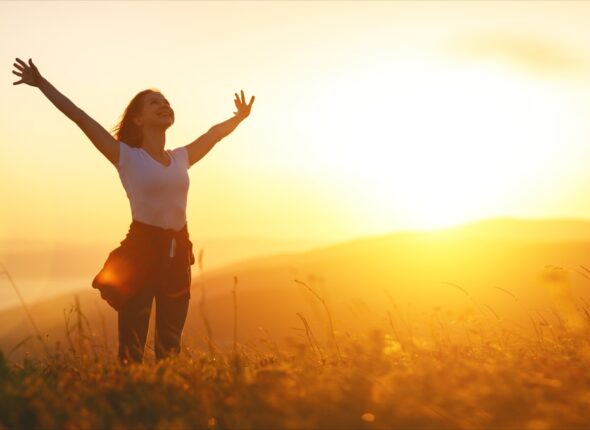 happy-woman-in-nature-at-sunset